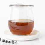Honey lavender simple syrup in a glass jar.