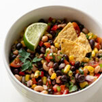 Healthy Cowboy Caviar in a white dish with chips.