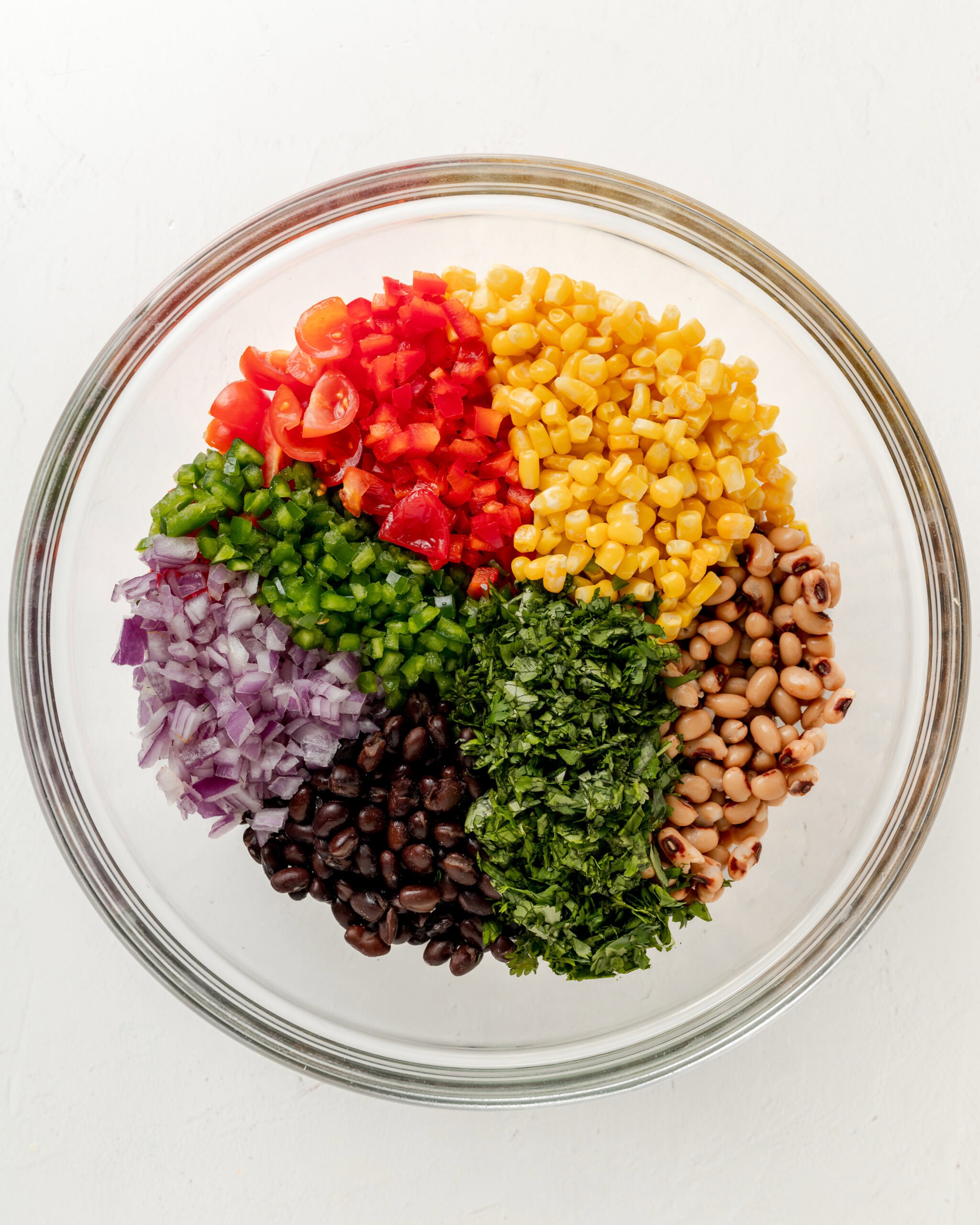 Cowboy caviar vegetables in a clear bowl.