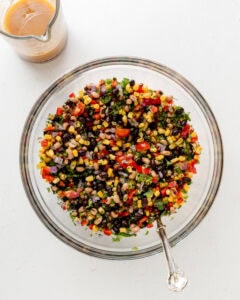 Adding the vinaigrette to the cowboy caviar.
