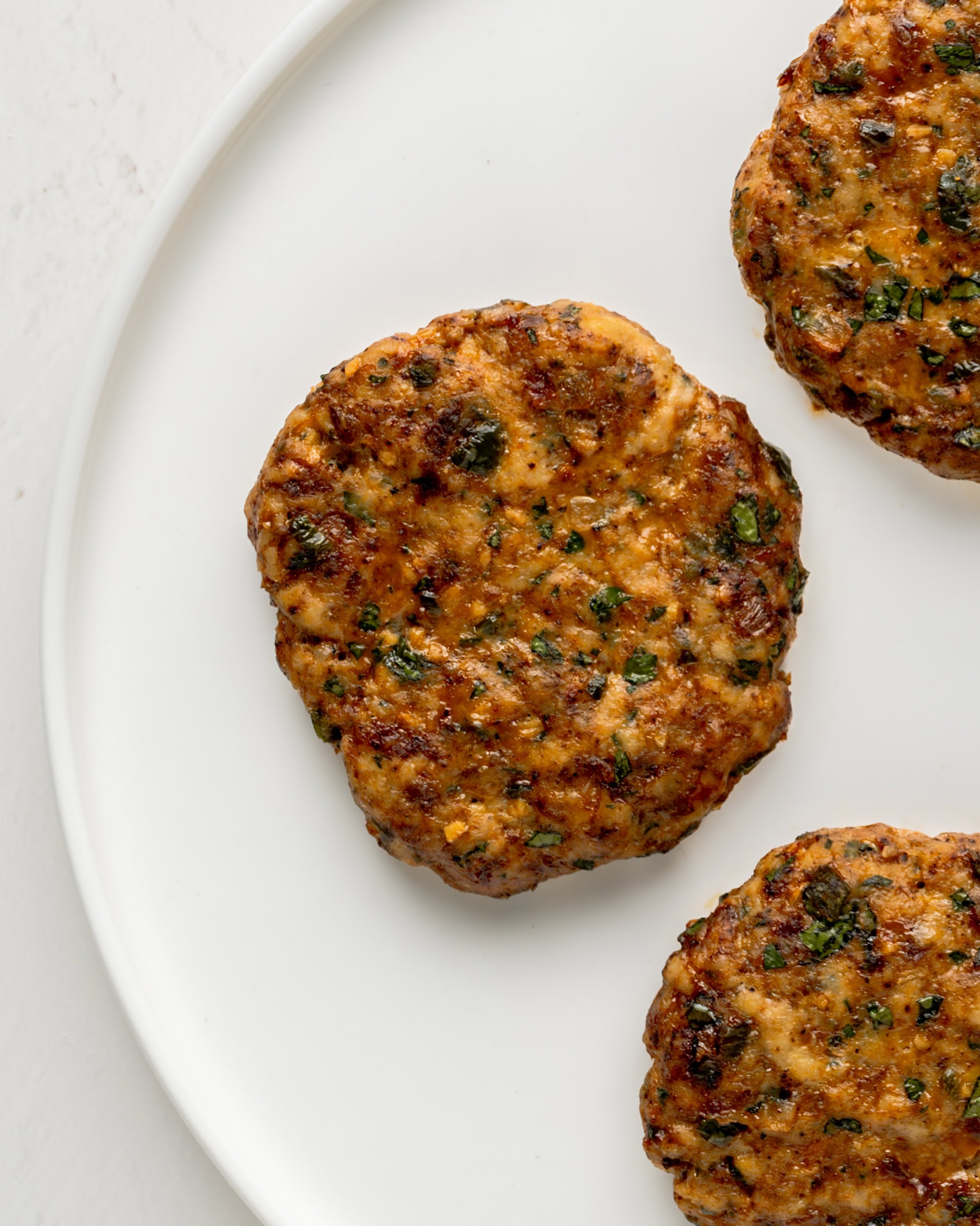 Spicy Chicken Burgers on a white plate.