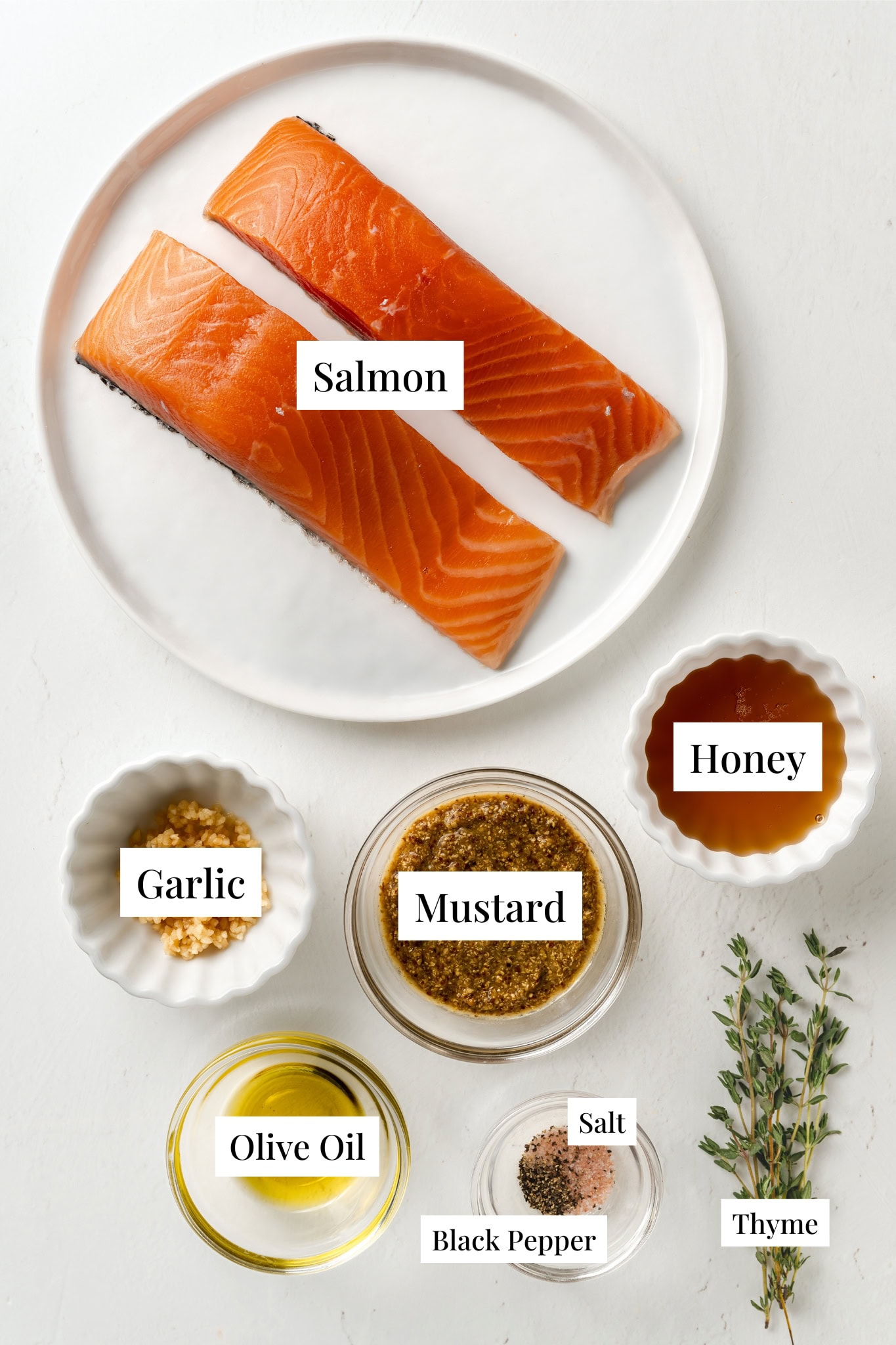 Ingredients for mustard salmon. Salmon, honey, garlic, mustard, olive oil, thyme, salt and black pepper.
