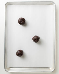 Chocolate Cookie Dough On A Lined Baking Sheet.