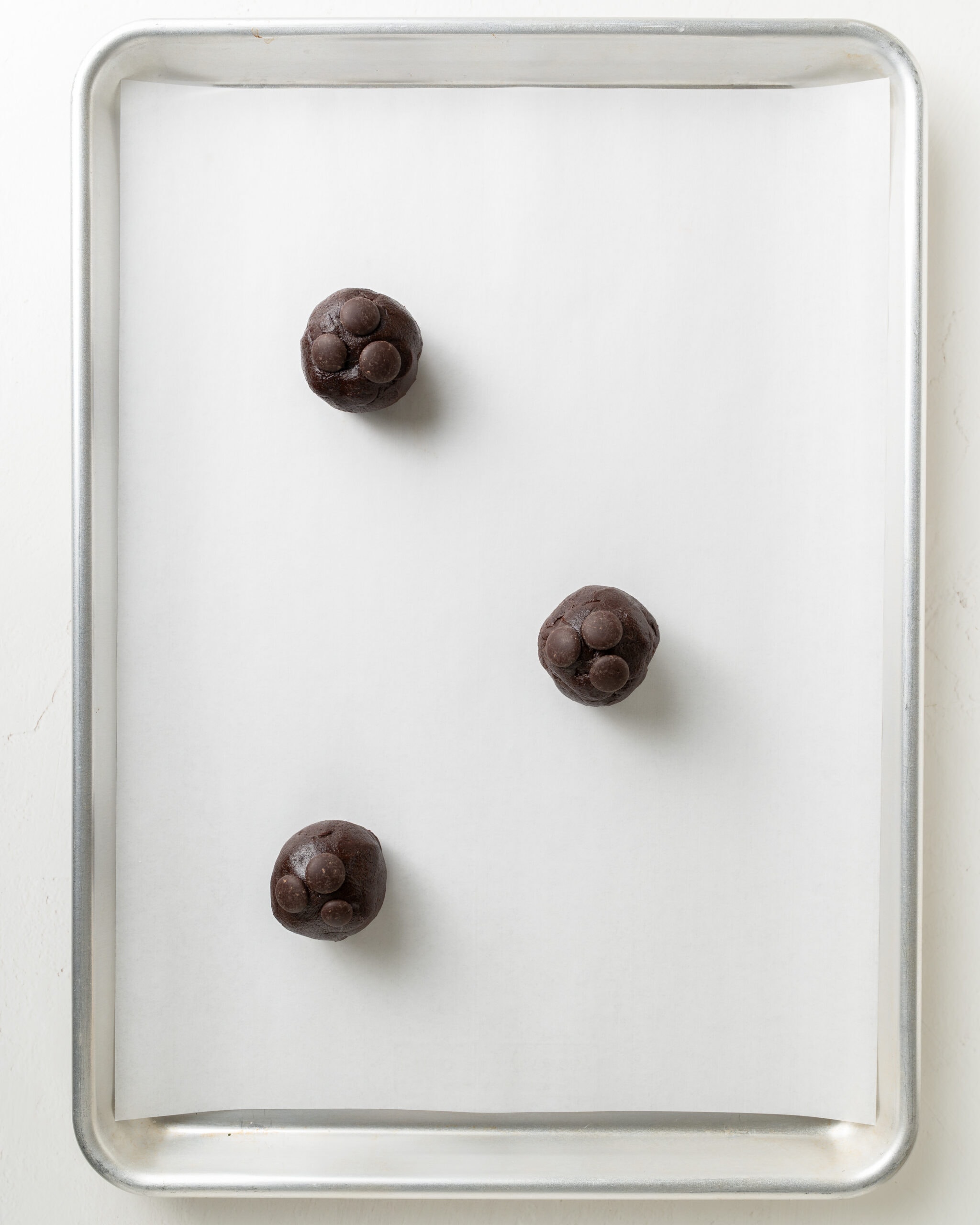 Chocolate Cookie Dough On A Lined Baking Sheet.
