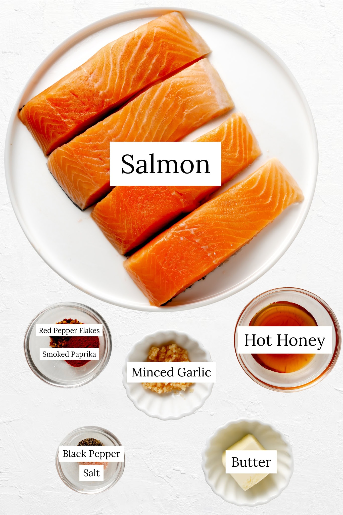 Hot honey salmon ingredients. Salmon with bowls of spices, butter, and hot honey.