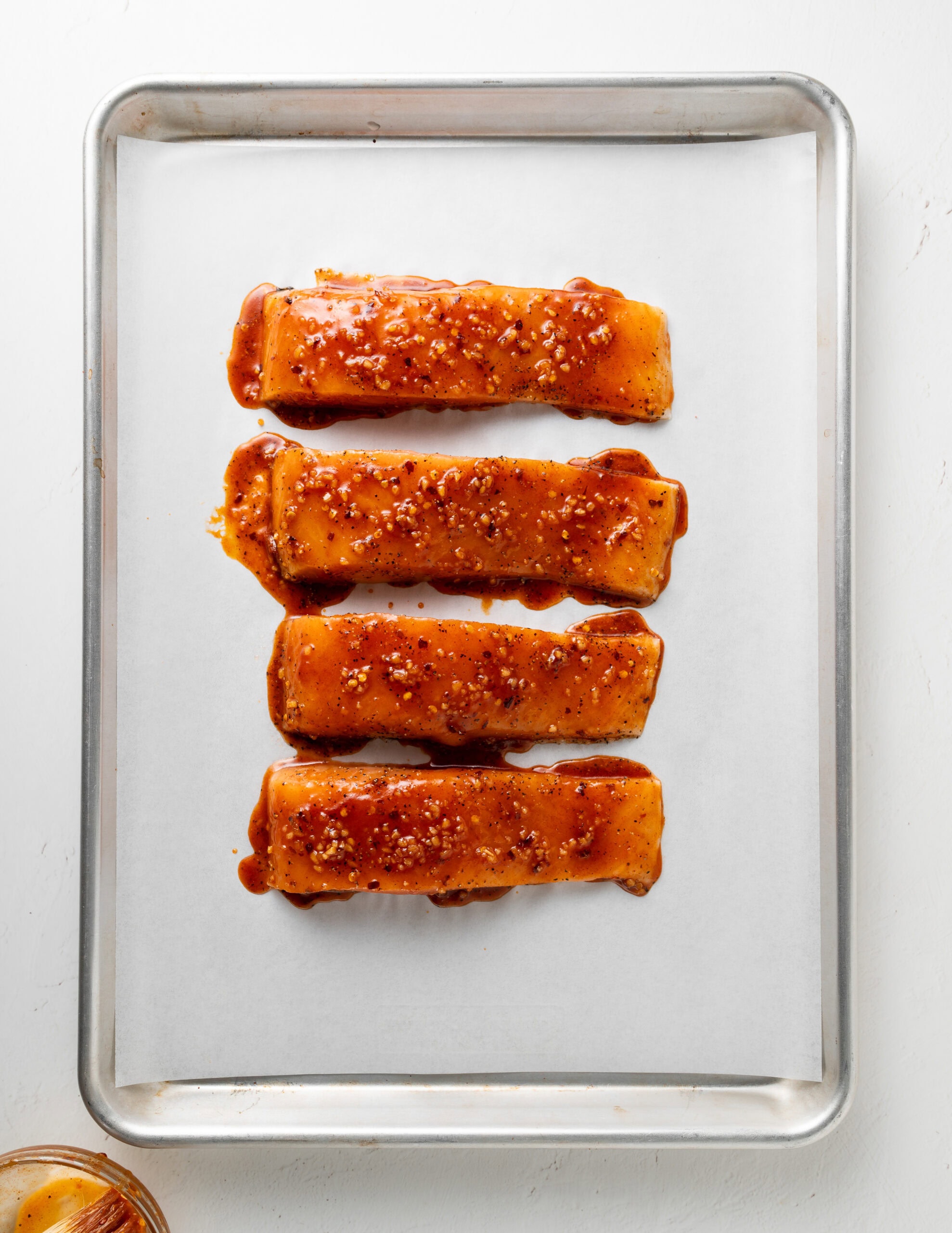 Hot honey salmon on baking sheet.