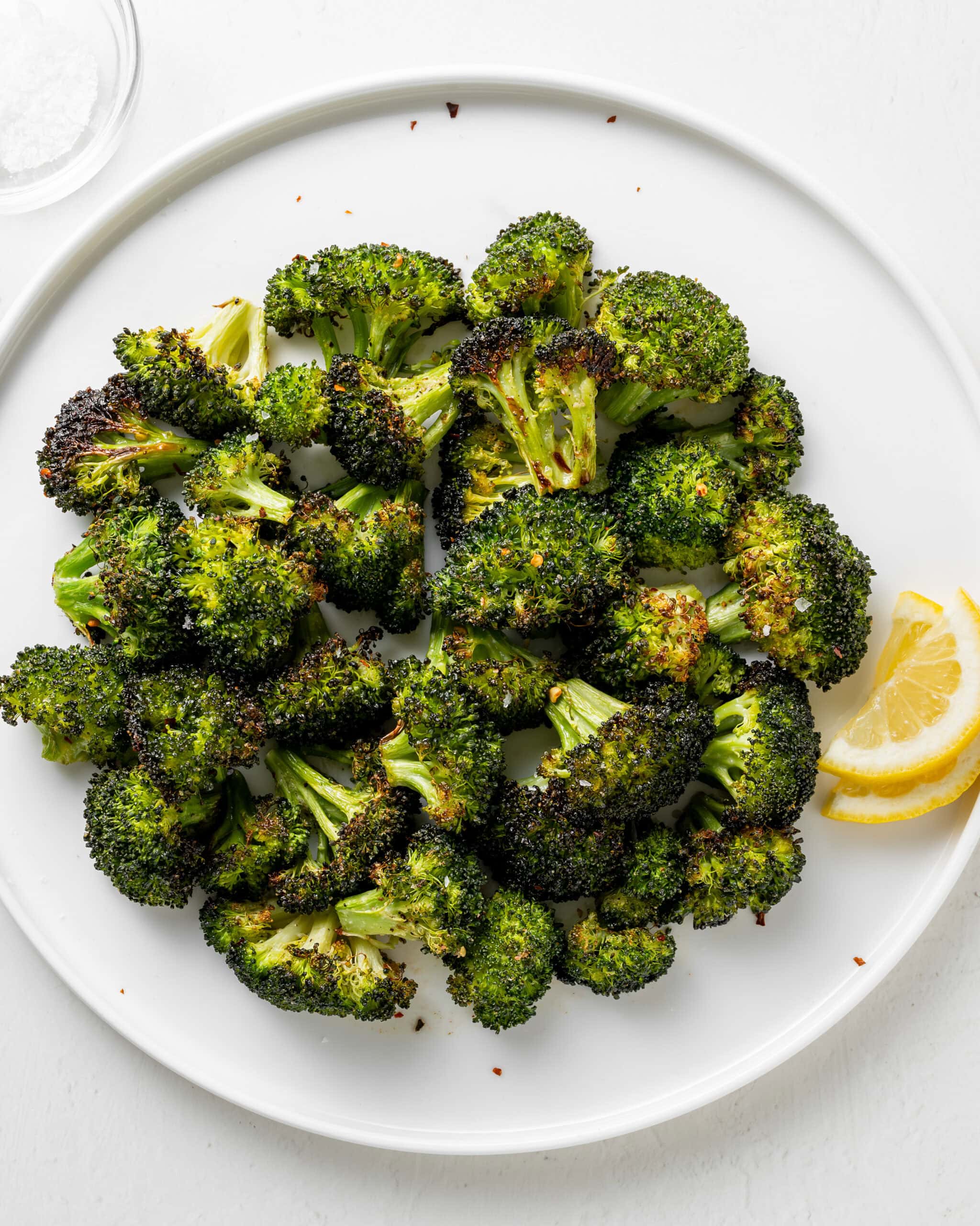 Broccoli on a plate with lemon.