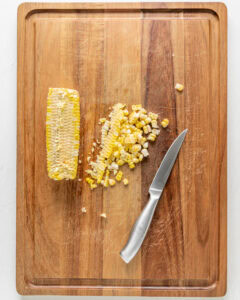 Cutting corn off the cob.
