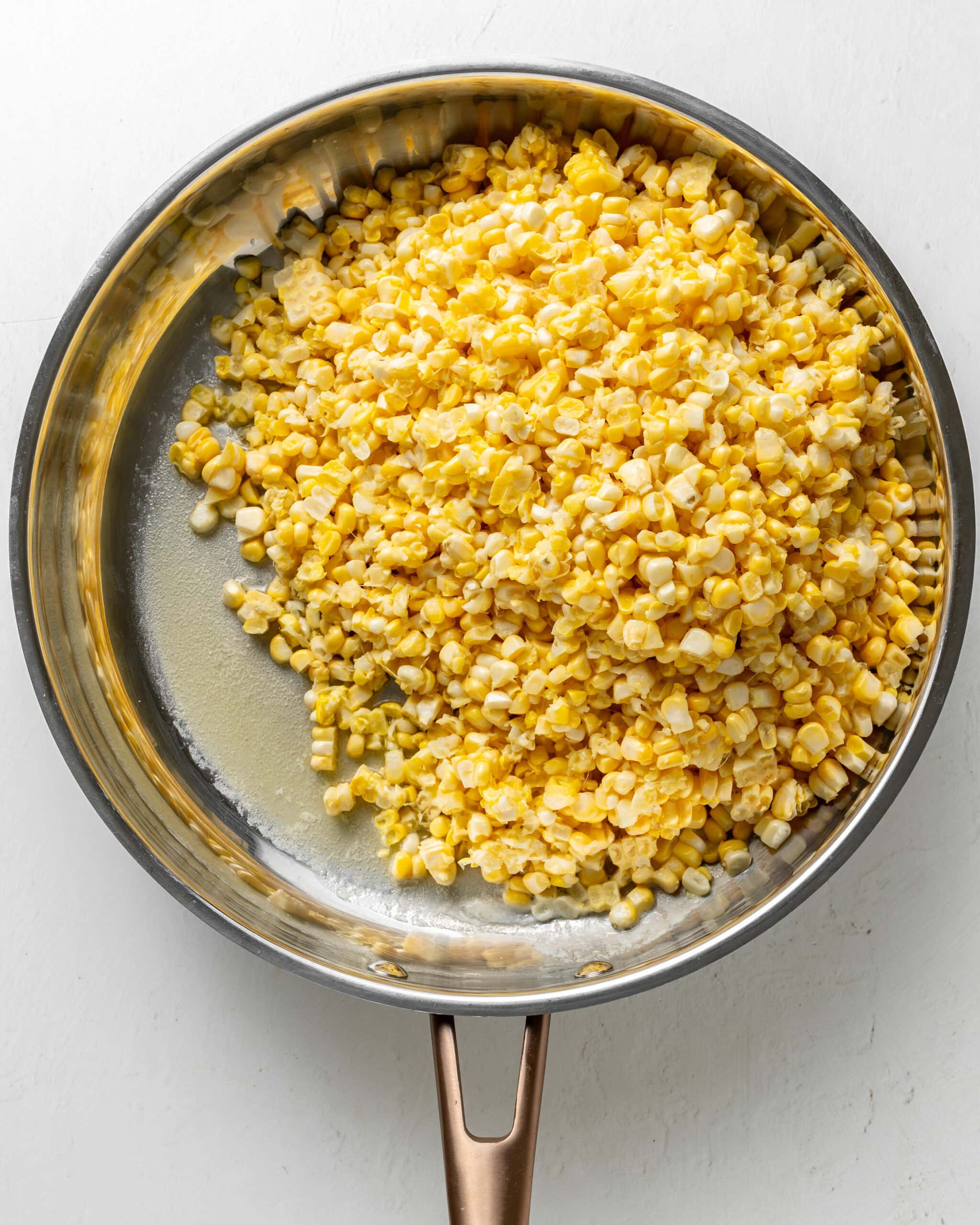 Creamed corn in a skillet with butter.