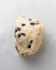 Blueberry scone dough cut and stacked for lamination.