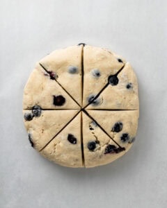 Blueberry Scone Dough Cut Into 8 Triangles.