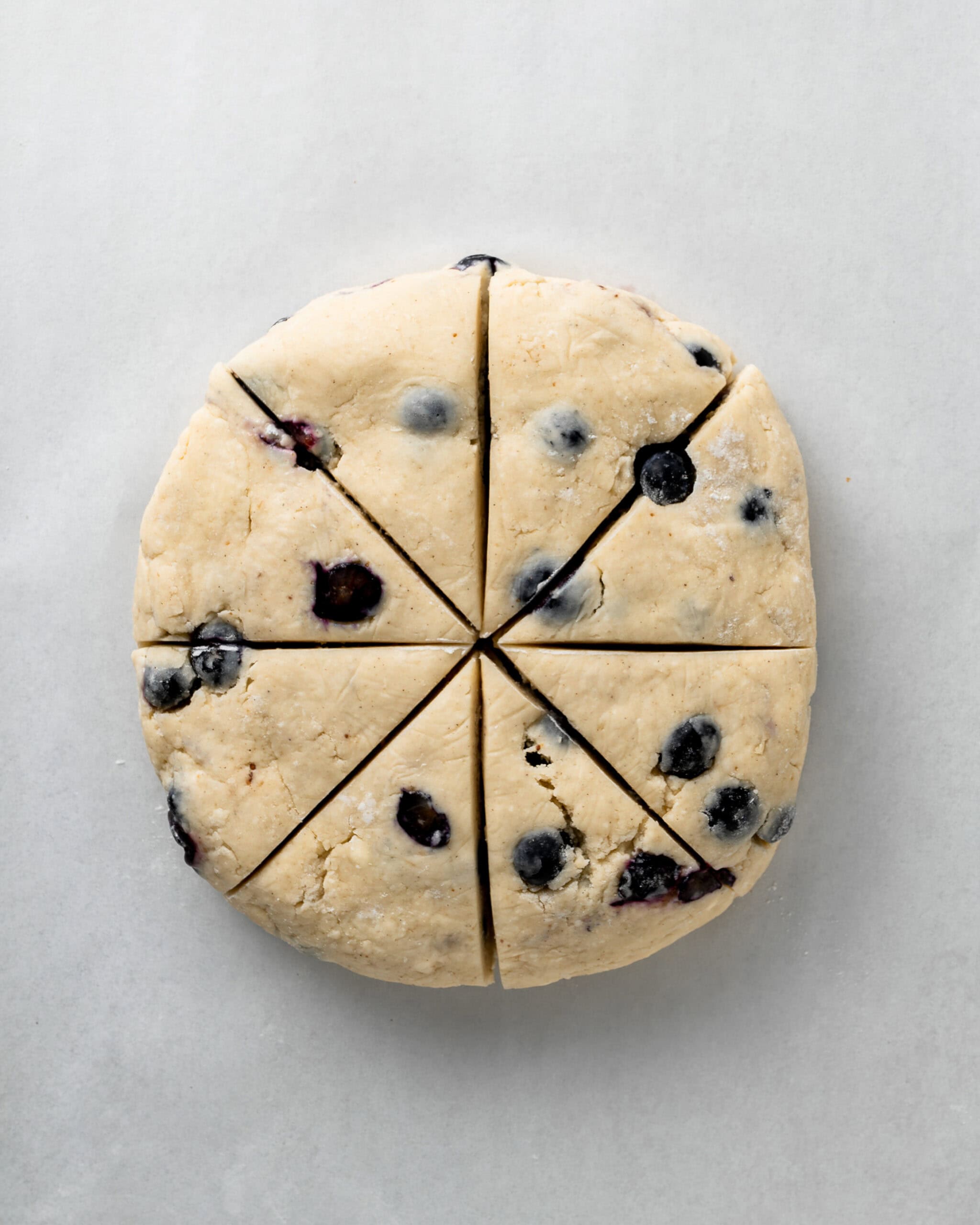 Blueberry Scone Dough Cut Into 8 Triangles.