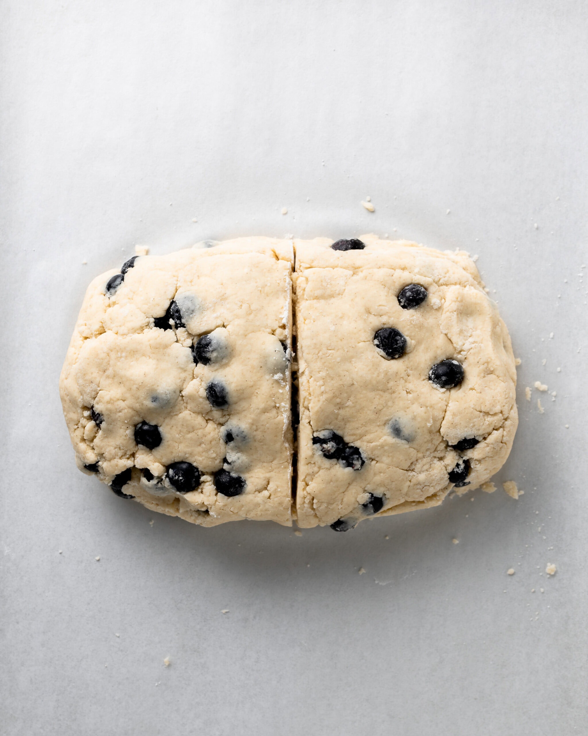 Blueberry scone dough cut in half.