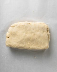 Cut, stack, and flatten the scone dough.