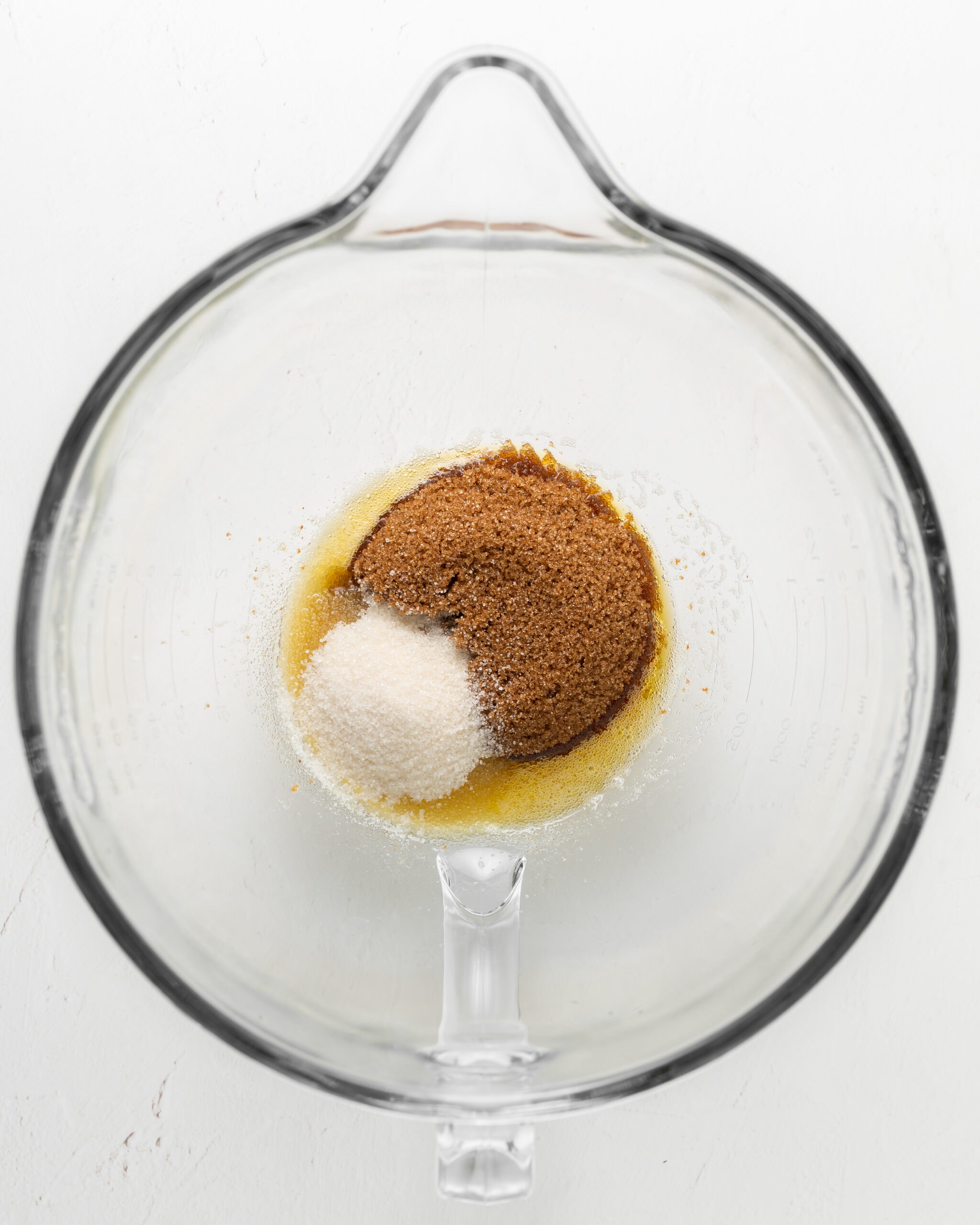 Mixing dark brown sugar and granulated sugar.