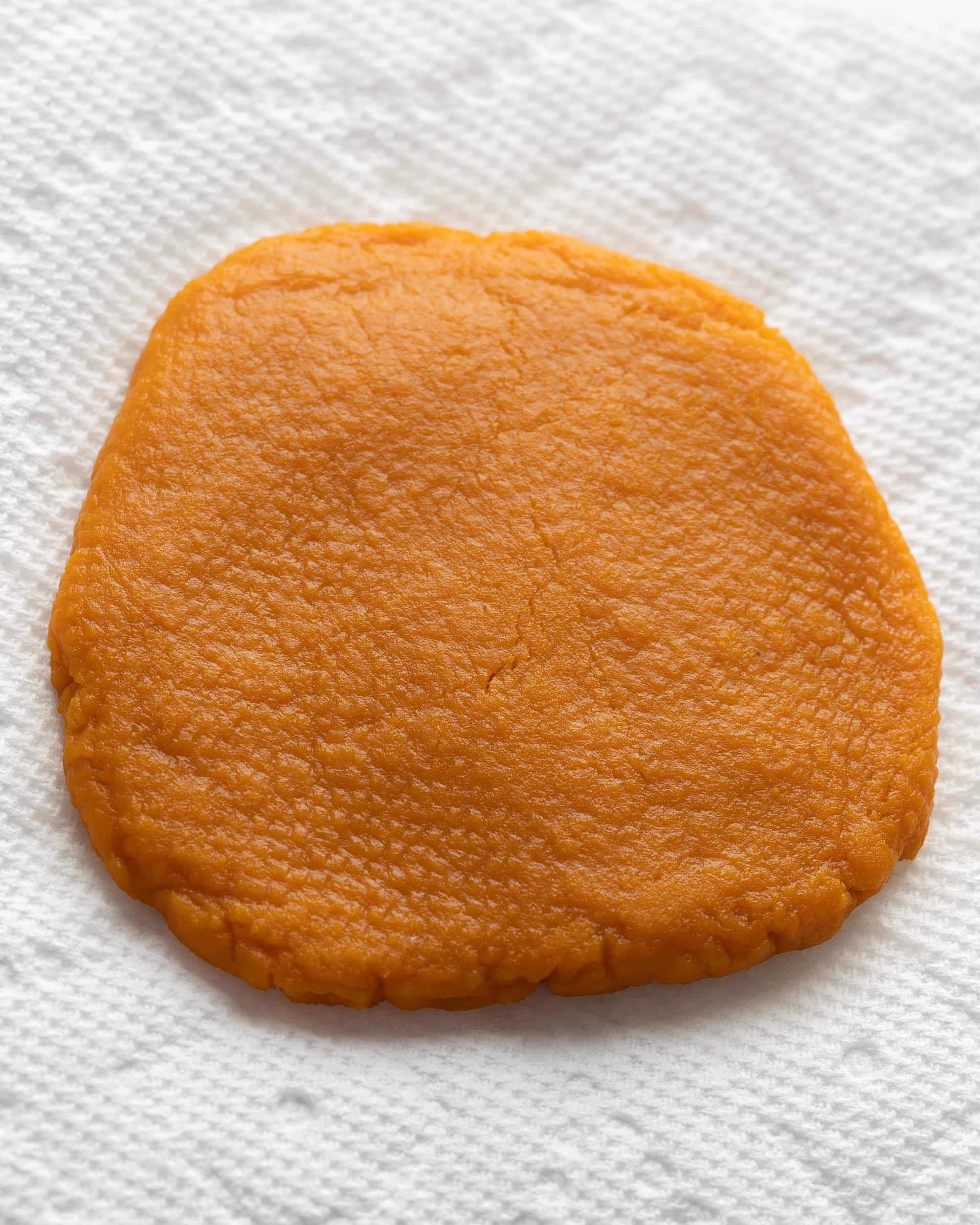 Blotting pumpkin on a white paper towel.
