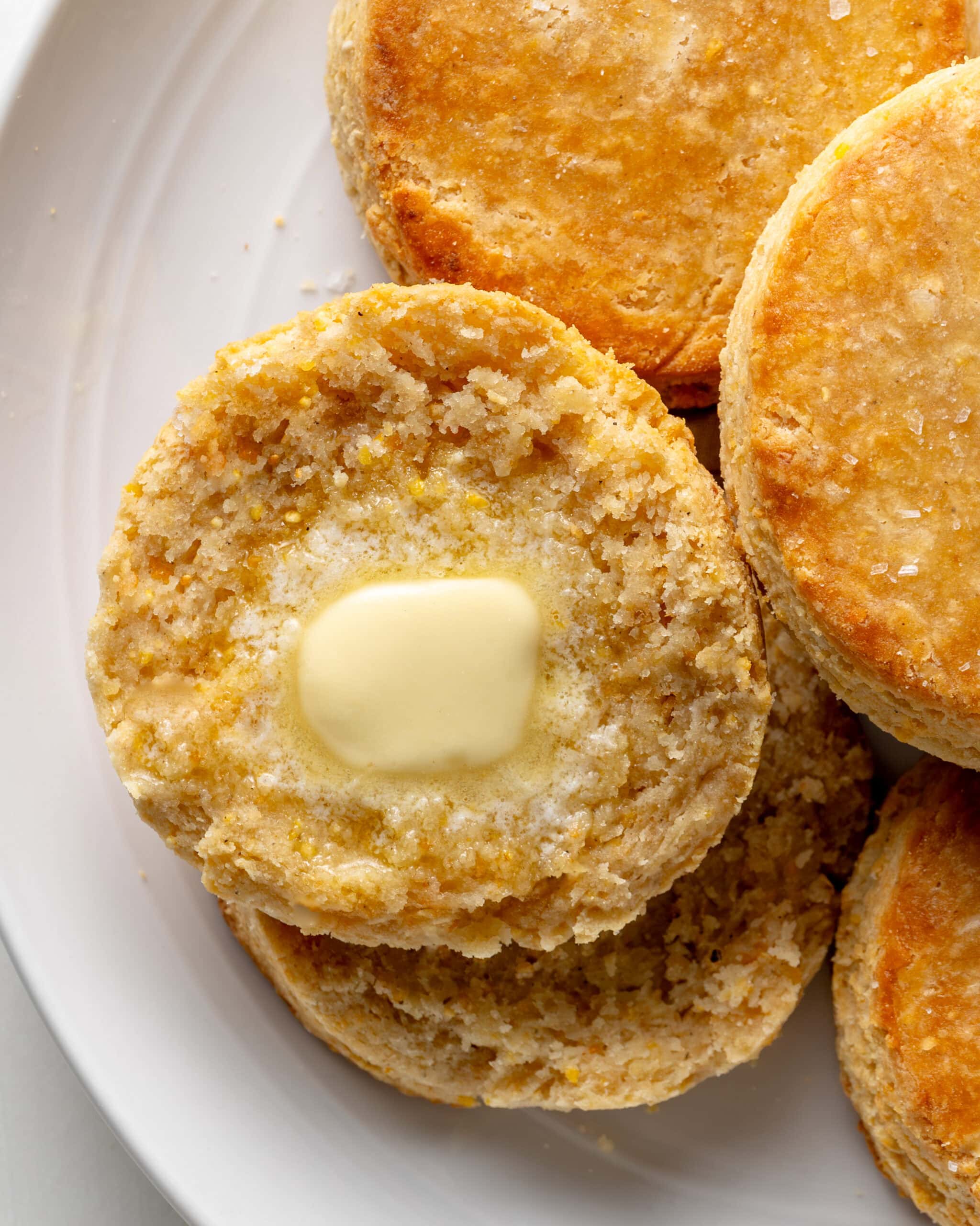 Cornmeal biscuit with butter smeared and melted on inside.