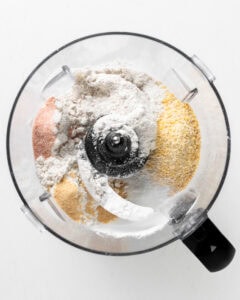Add dry ingredients to a food processor for cornmeal biscuits.