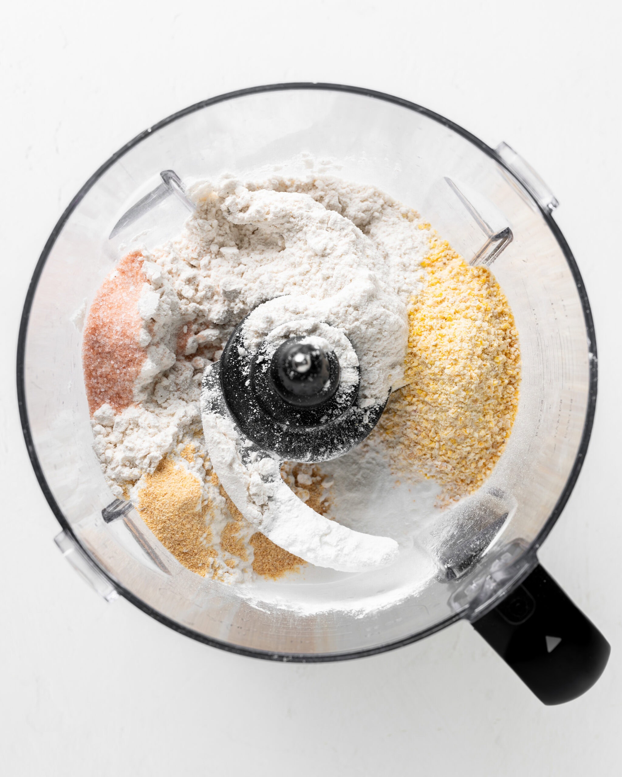 Add dry ingredients to a food processor for cornmeal biscuits.