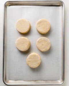 unbaked cornmeal biscuits on baking sheet.