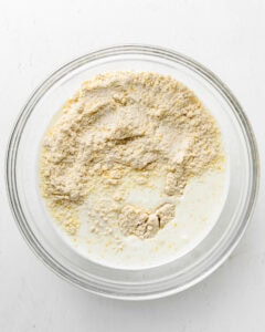 Mixing wet and dry ingredients for cornmeal biscuits.