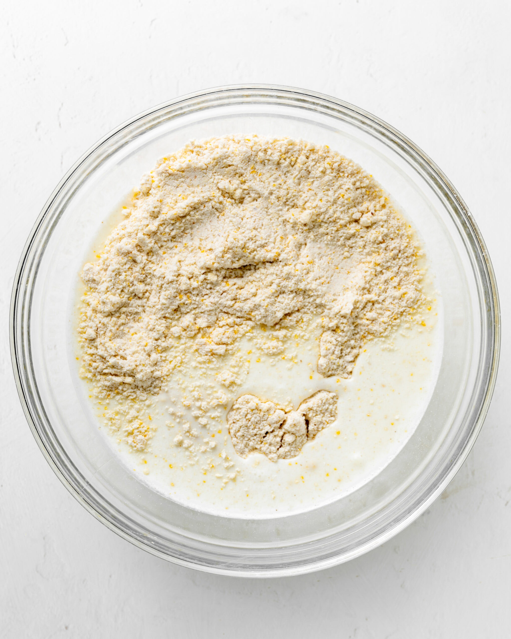 Mixing wet and dry ingredients for cornmeal biscuits.
