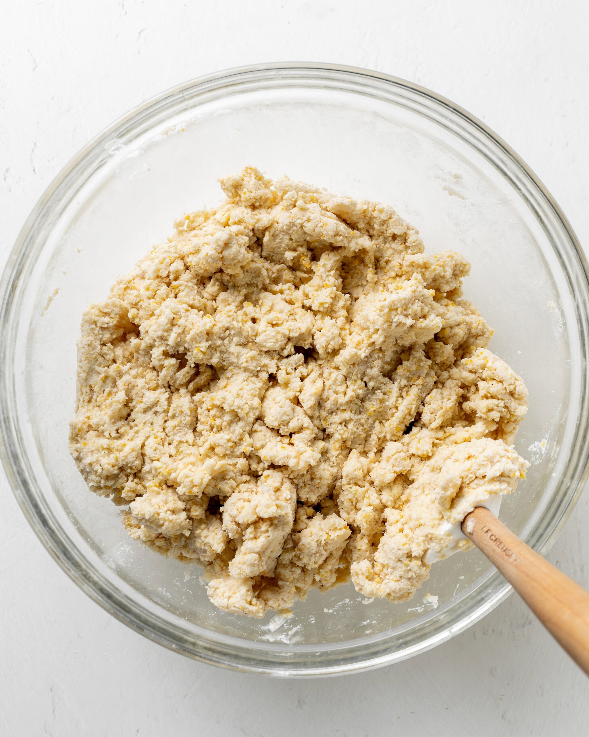 Stirring the dough together for cornmeal biscuits.