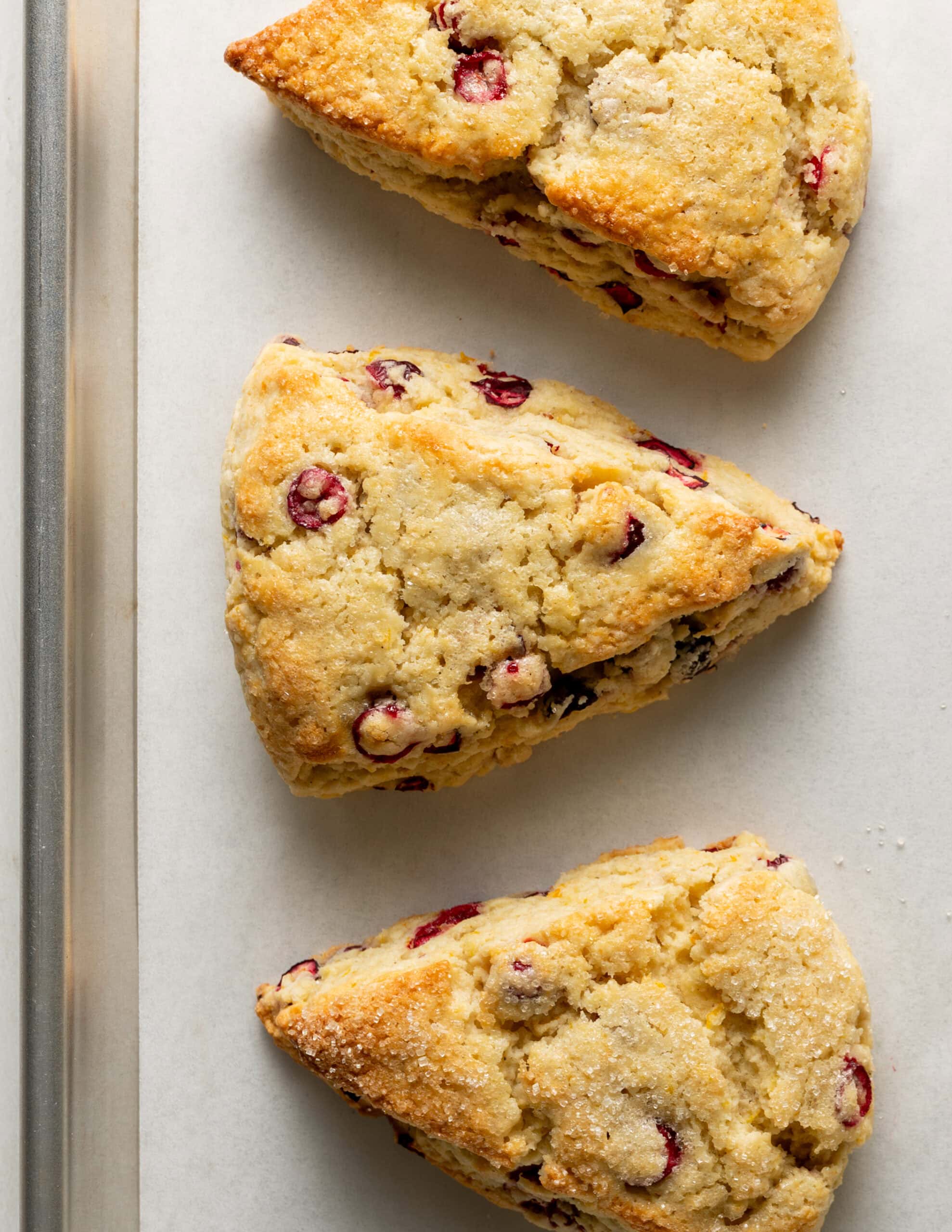 Close up of gluten free cranberry orange scones on baking tray.