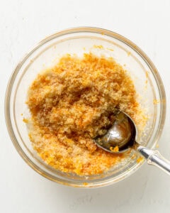 Orange zest and sugar mixed together in a small bowl.