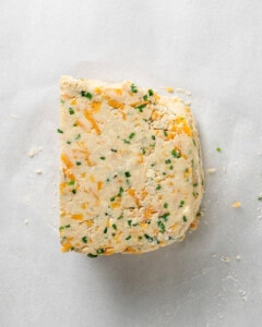 Stack the scone dough pieces together to laminate.