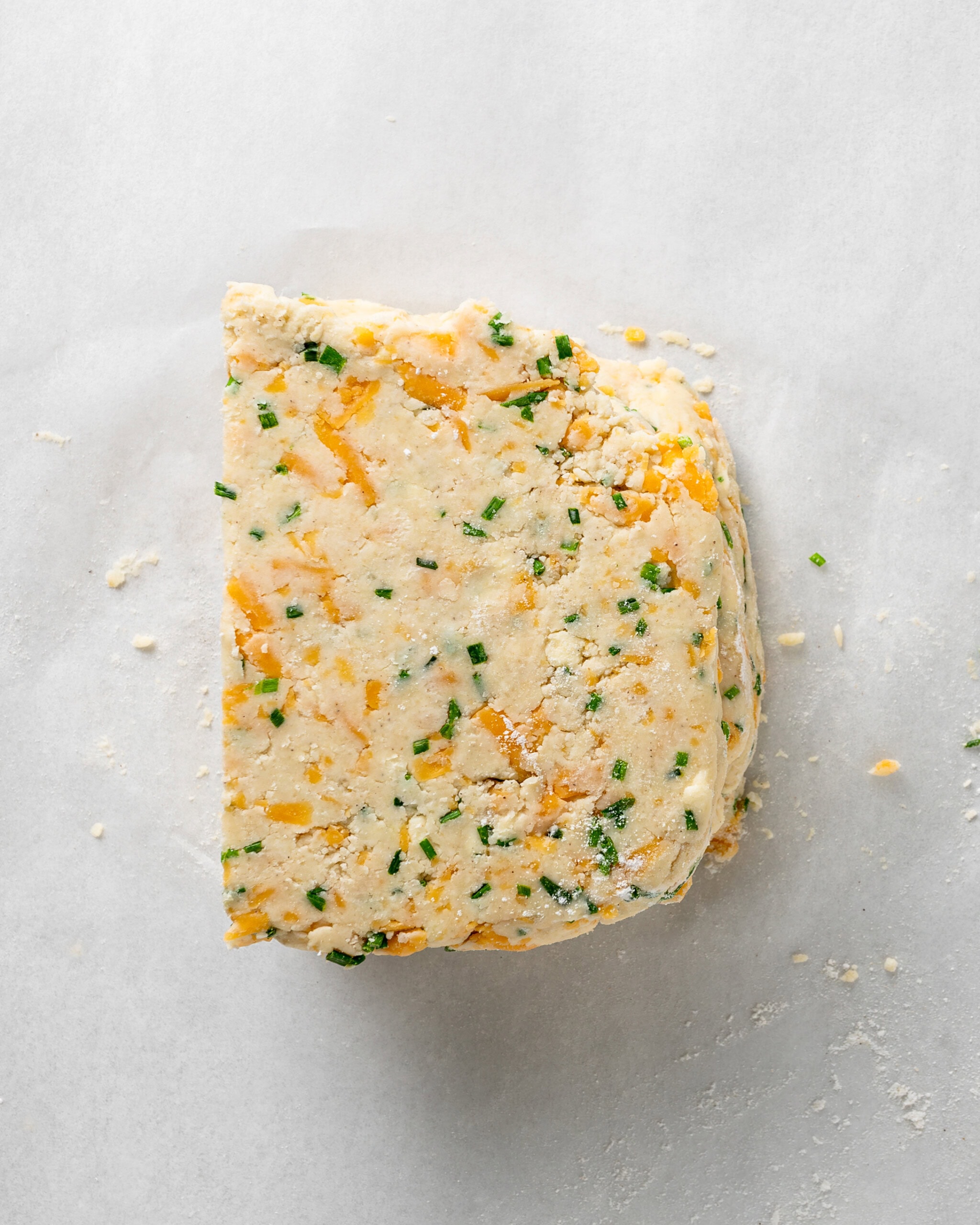 Stack the scone dough pieces together to laminate.