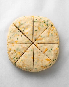 Cheddar and chive dough cut into 8 triangles.