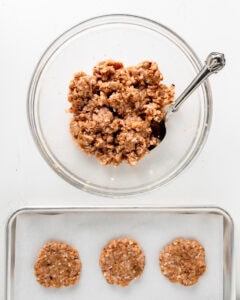 Ground chicken stirred together with spices and formed into 3 patties, placed on a parchment lined baking sheet.