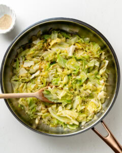 Cabbage sauteed in frying pan.