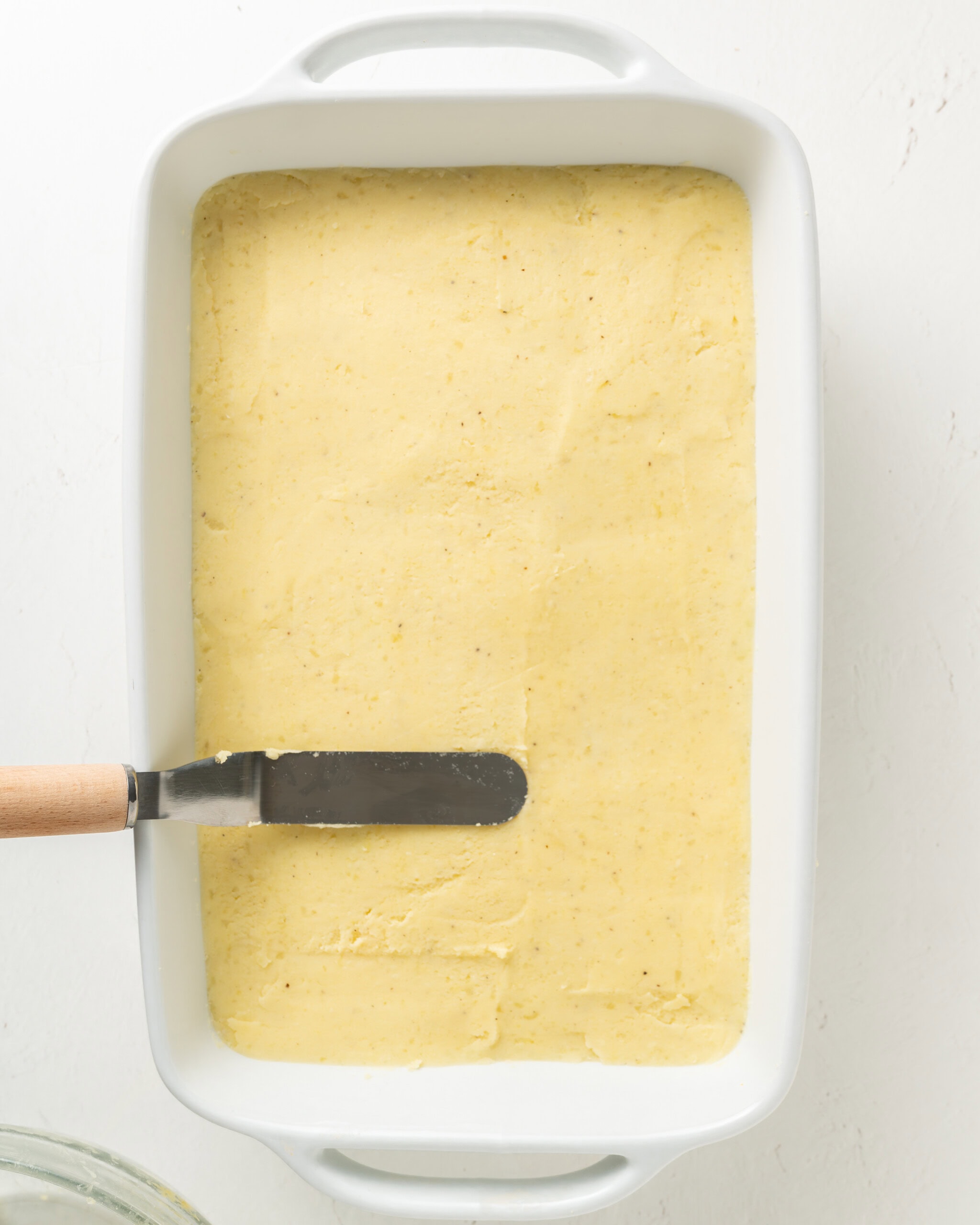 Adding mashed potatoes with the top of shepherd's pie.