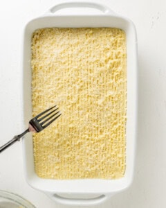 Using a fork to make lines on top of shepherd's pie.