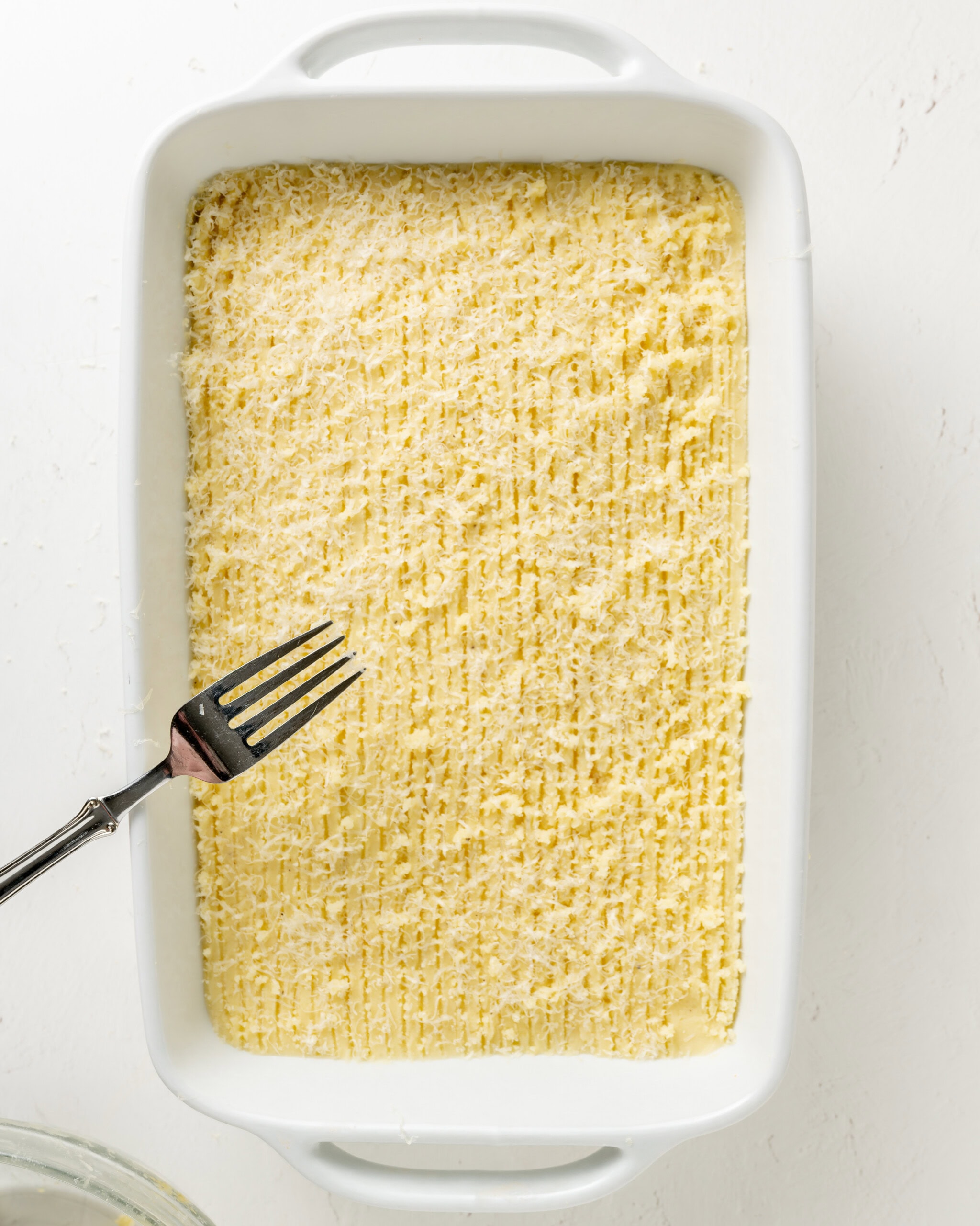 Using a fork to make lines on top of shepherd's pie.