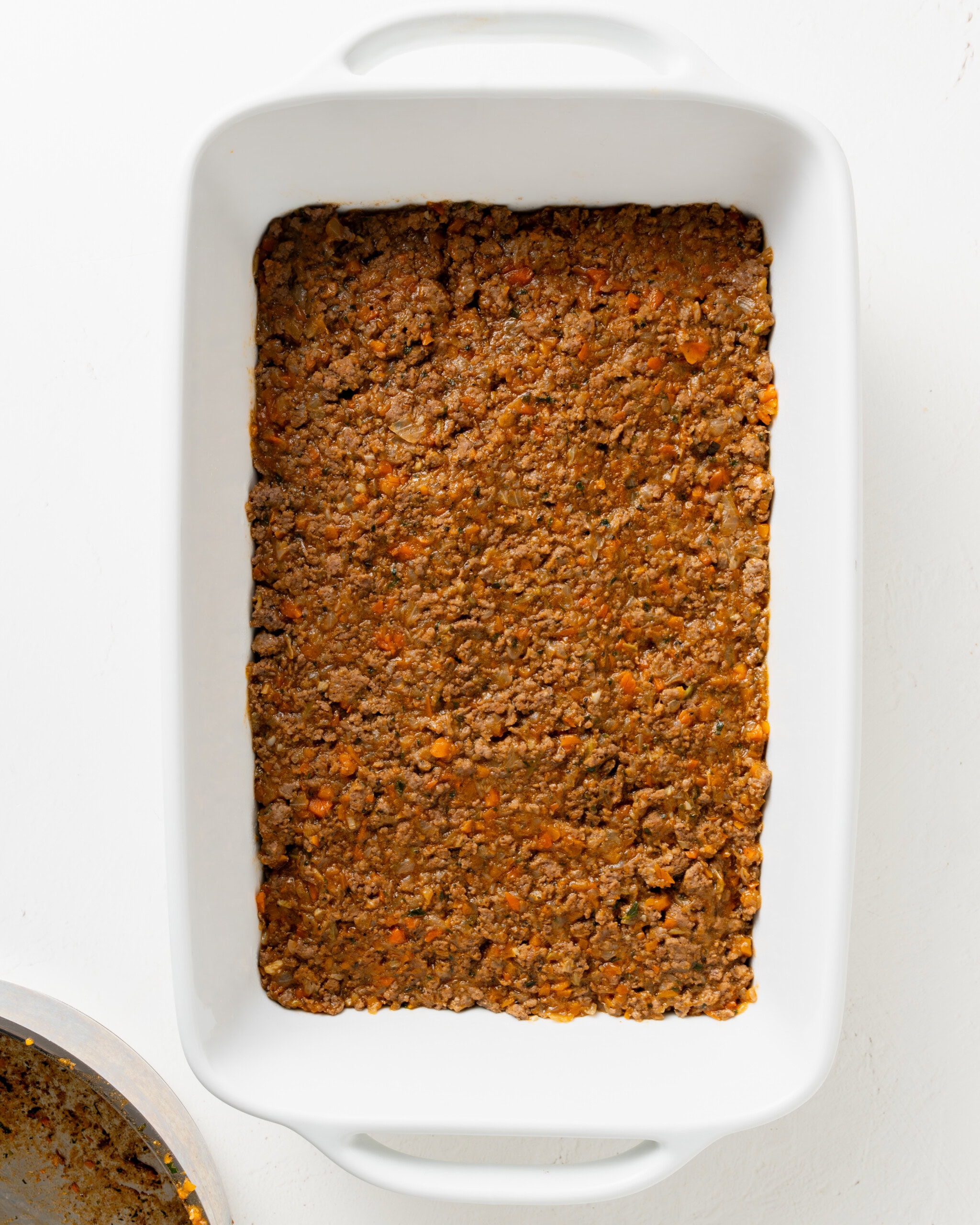 Lamb mixture in casserole dish for shepherds pie.