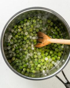 Boiling marrowfat peas and skimming the skins on top of the water.