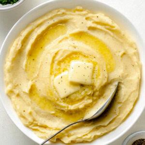 Yukon Gold Mashed Potatoes in a white bowl with spoon.