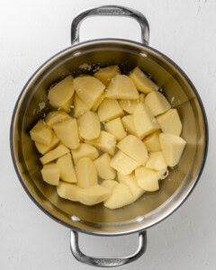 Boiled potatoes in stainless steel pot.