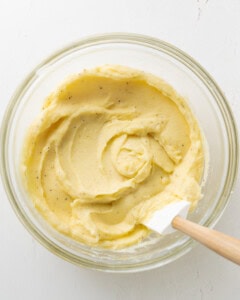 Mixing the yukon potatoes together with a rubber spatula.
