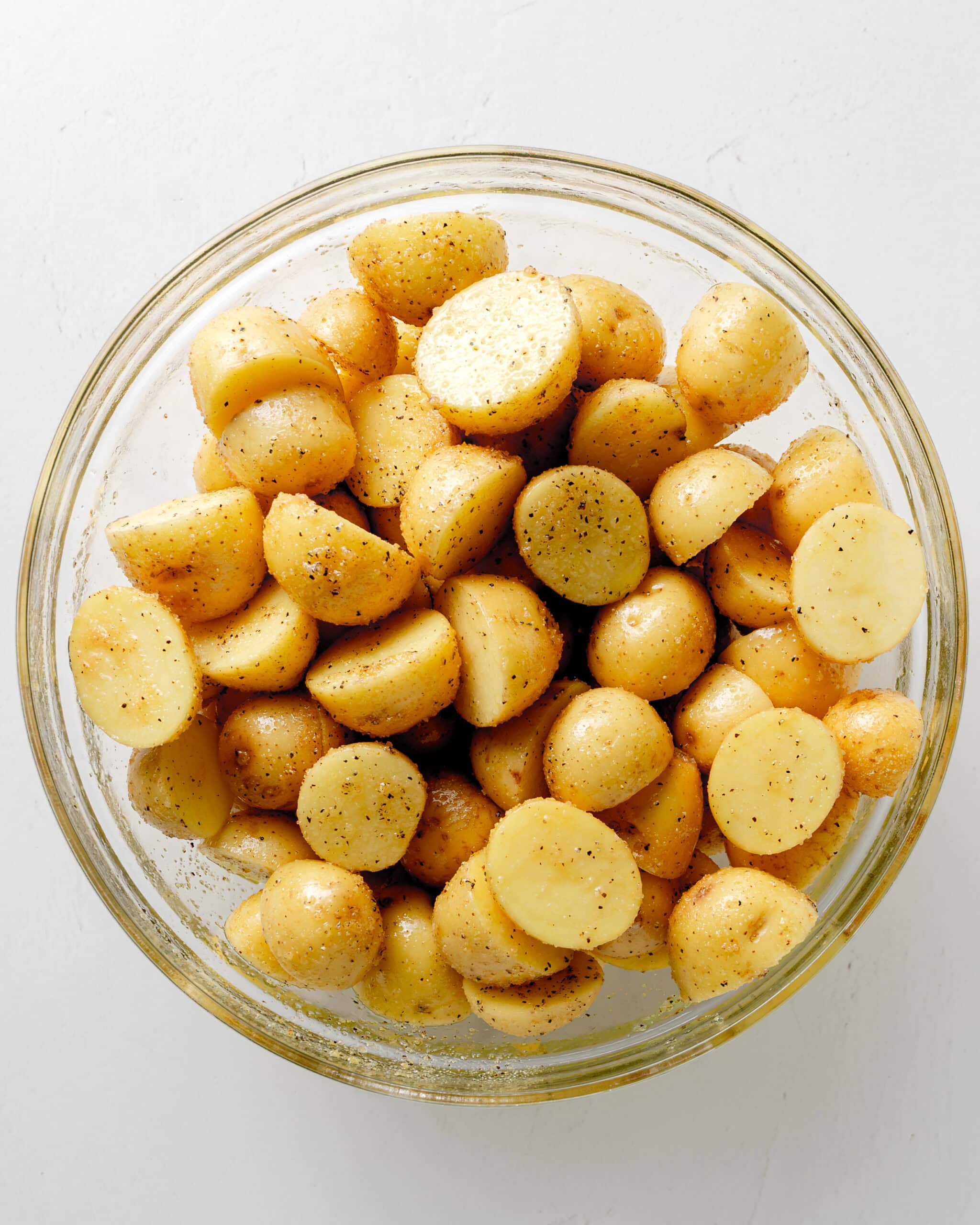 Yellow potatoes tossed with seasonings and oil.