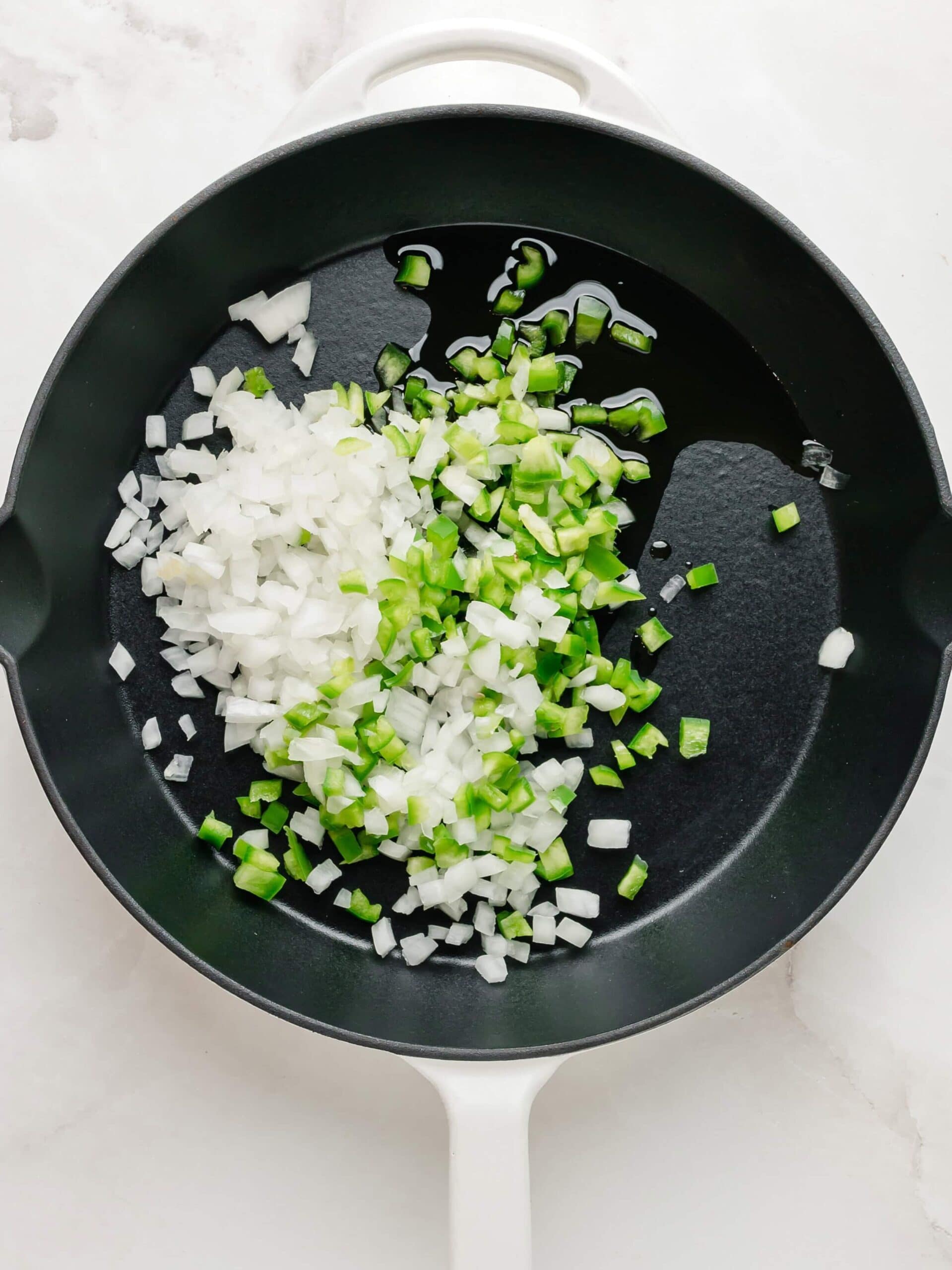 Sauteed onion and green pepper n a large black skillet.